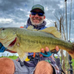 Best Bass Lures For Fall 2025 Man with bass.