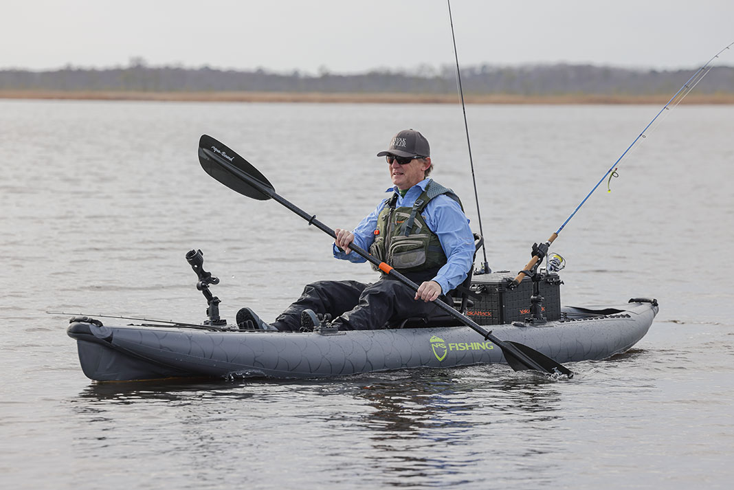 man paddles kayak