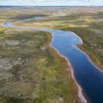 overhead photo of a canoe paddled down a river in the Barren Lands