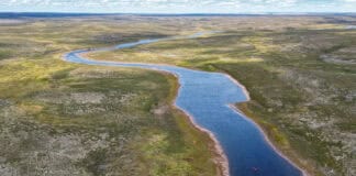 overhead photo of a canoe paddled down a river in the Barren Lands