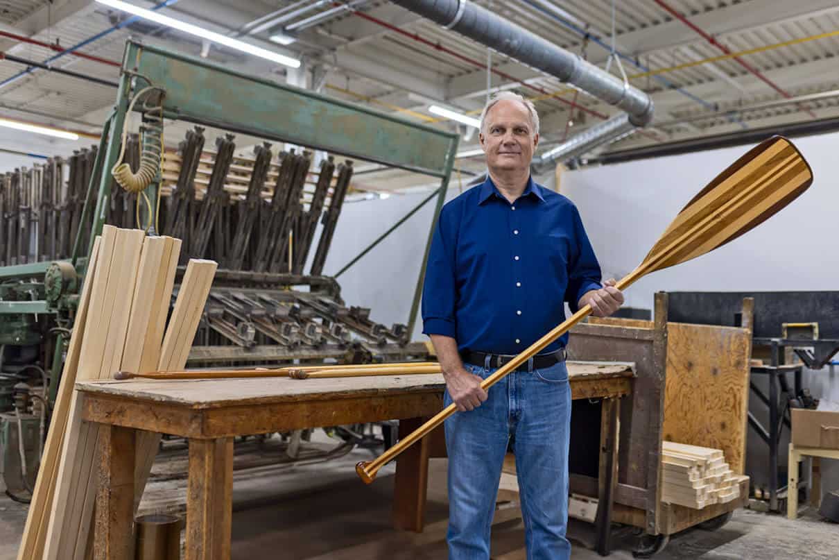 Roustan Sports Ltd. Chairman W. Graeme Roustan holds a paddle in his factory after acquiring Grey Owl Paddles in the brand’s 50th year