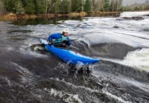 man paddles the Dagger Indra whitewater kayak in a rapid