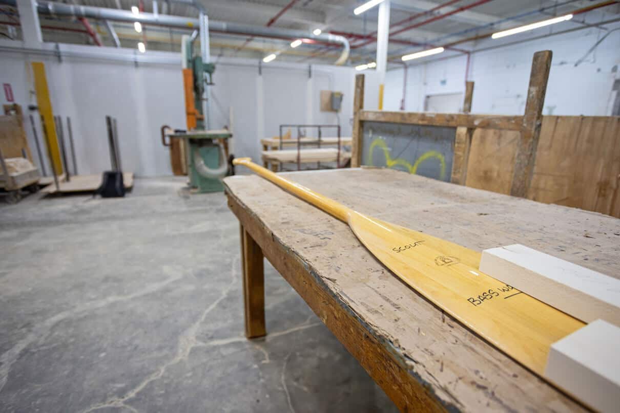 a Grey Owl paddle sits on a table at the factory