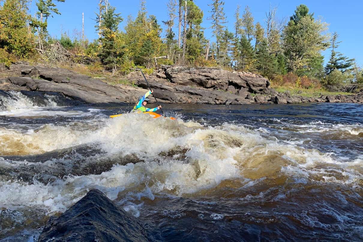 Tove kayaks through Iron Ring Rapid