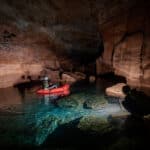 packrafts travel by flashlight through subterranean tunnels in the Grand Canyon