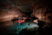 packrafts travel by flashlight through subterranean tunnels in the Grand Canyon