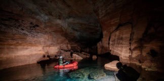 packrafts travel by flashlight through subterranean tunnels in the Grand Canyon