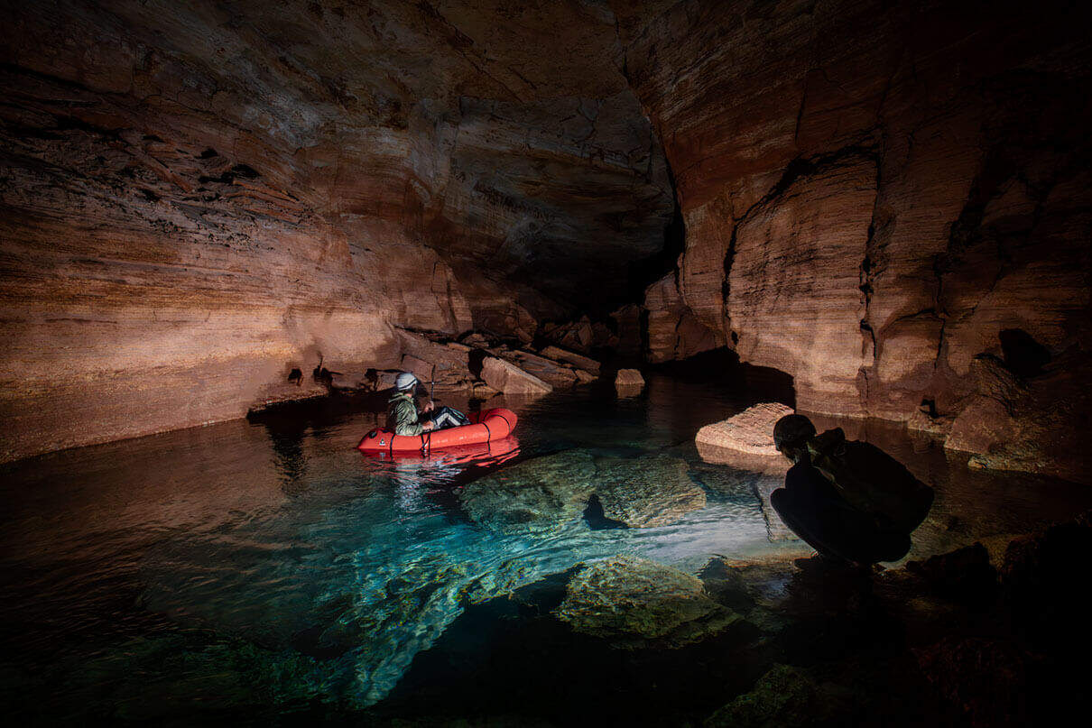 packrafts travel by flashlight through subterranean tunnels in the Grand Canyon
