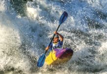 Woman whitewater kayaking