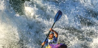 Woman whitewater kayaking