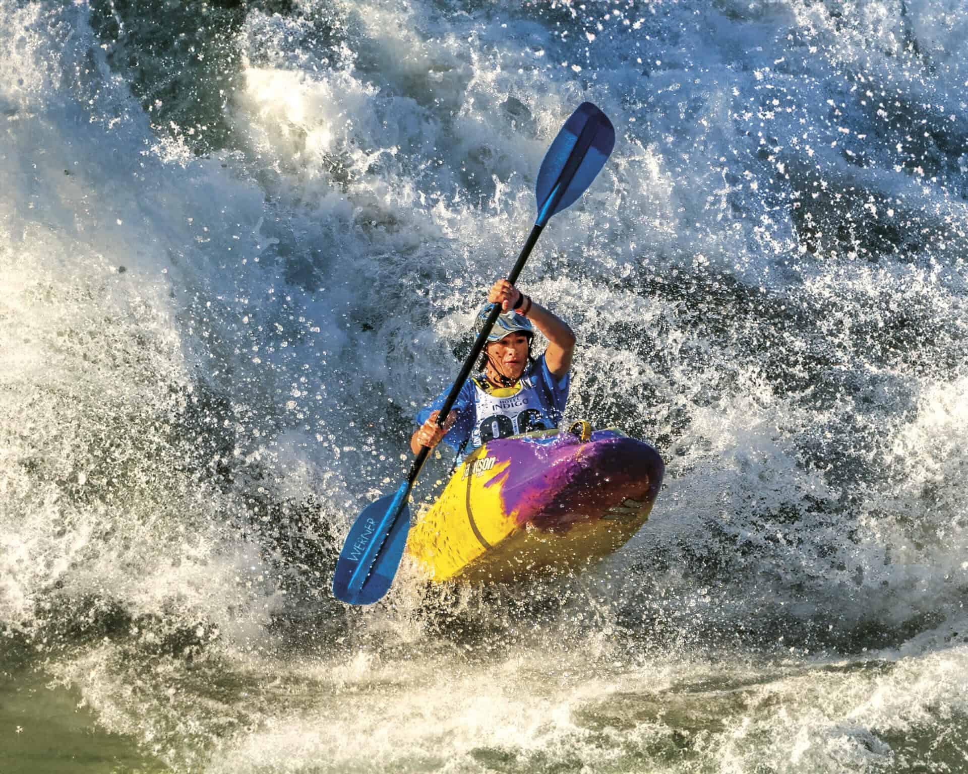 Woman whitewater kayaking