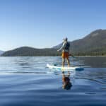The Best Places To Go Paddleboarding On Lake Tahoe Man standing on SUP.