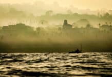 Chaos & Consolidation: Paddlesports Shakeups In 2025 a kayak angler fishes in golden light near the shore at La Jolla, California