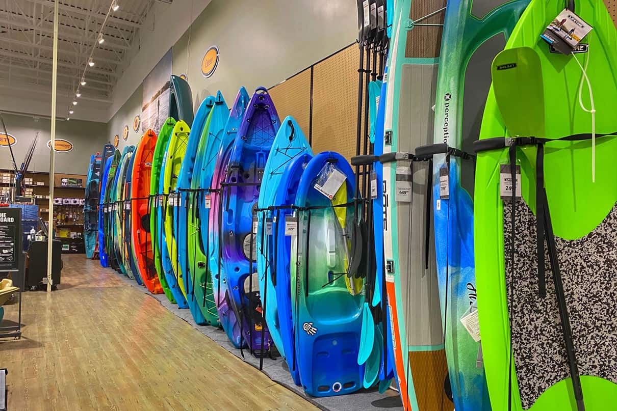 a number of Pelican kayaks on display at a paddle shop