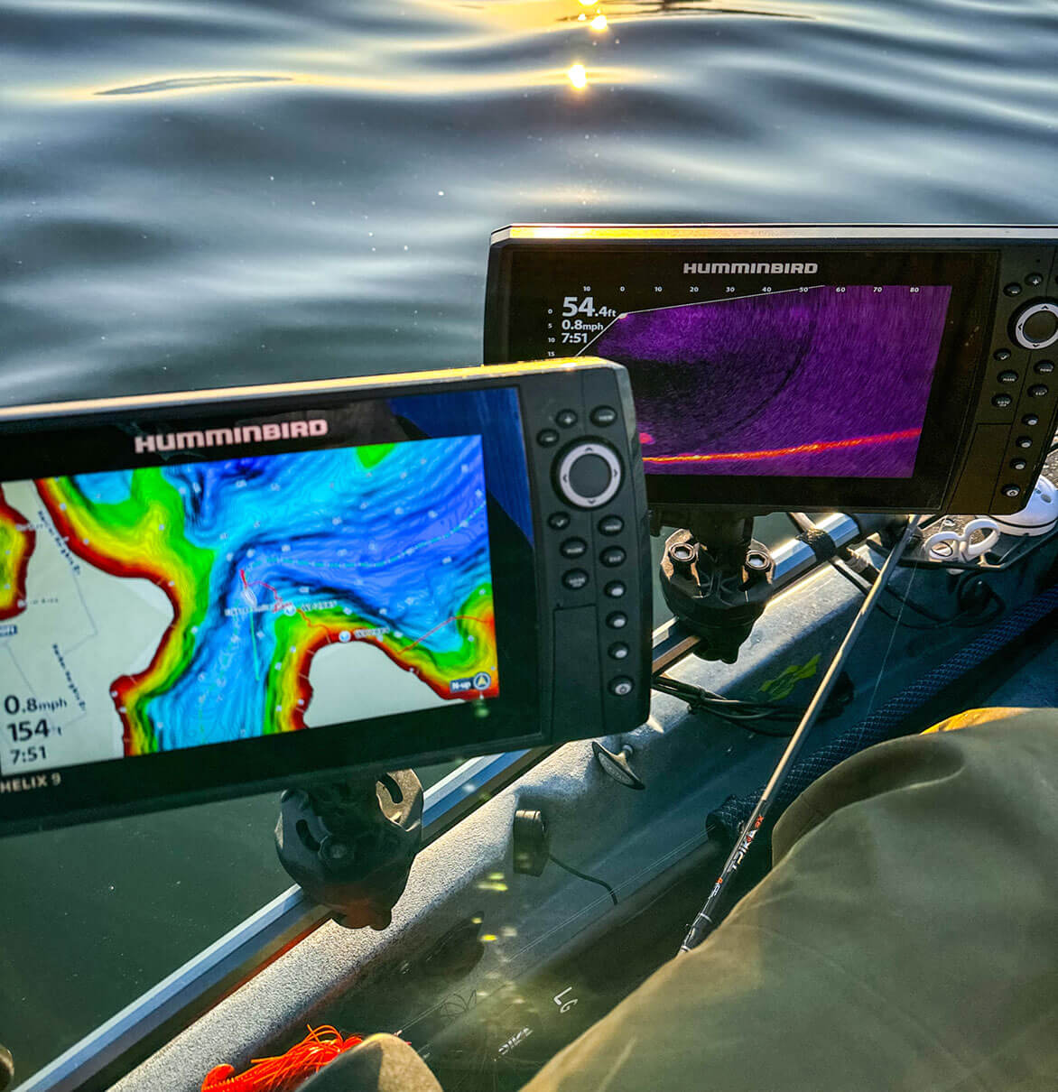 two fish finders mounted on a fishing kayak on the water