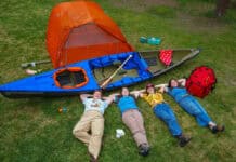 What’s Inside The Hudson Bay Girls’ Expedition Kit four members of the Hudson Bay Girls canoe expedition pose on a lawn with their gear for the trip