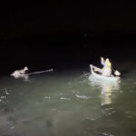 Griffin Marquis paddles out on frozen Derby Pond to rescue a deer.