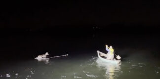 Griffin Marquis paddles out on frozen Derby Pond to rescue a deer.