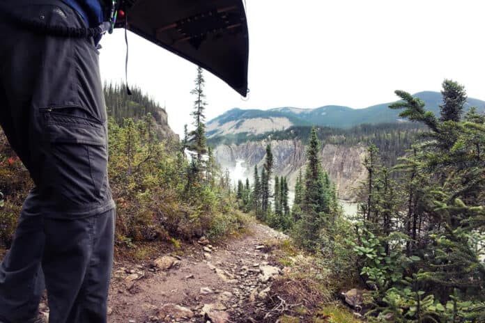 a person portages a canoe near Virginia Falls on the Nahanni River