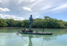 Sanibel Island, Florida: The Perfect Mix Of Peace And Fishing Adventure man stands and fishes from a kayak at Sanibel Island, Florida