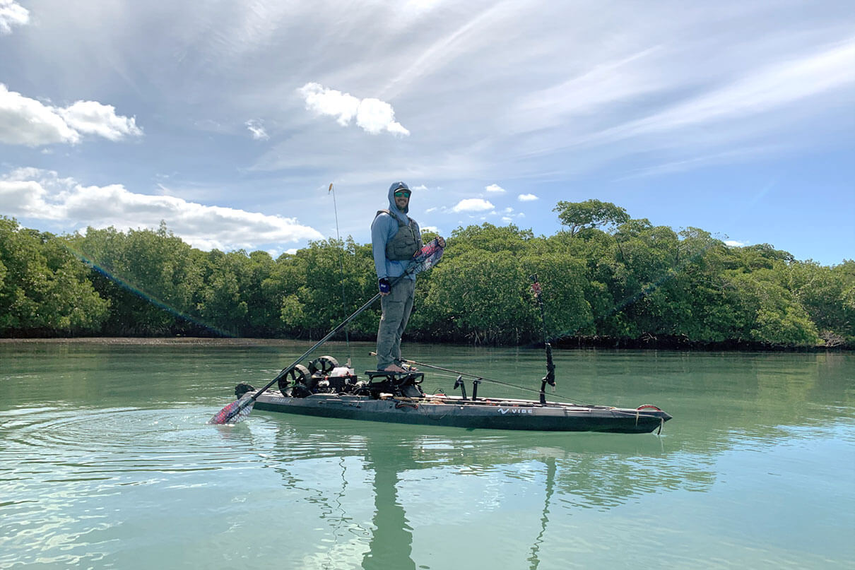 man stands and fishes from a kayak at Sanibel Island, Florida