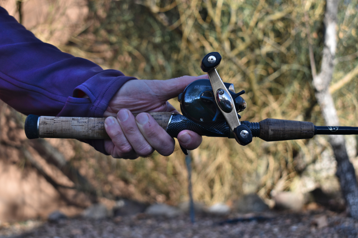 The author showing the correct way to hold a baitcasting rod.