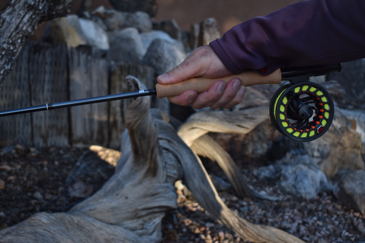 The author showing on a fly rod how different types of rods have different grips.