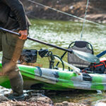 Essential Gear For Beginner Anglers beginner angler pulls his fishing kayak onto shore with gear