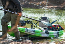 Essential Gear For Beginner Anglers beginner angler pulls his fishing kayak onto shore with gear