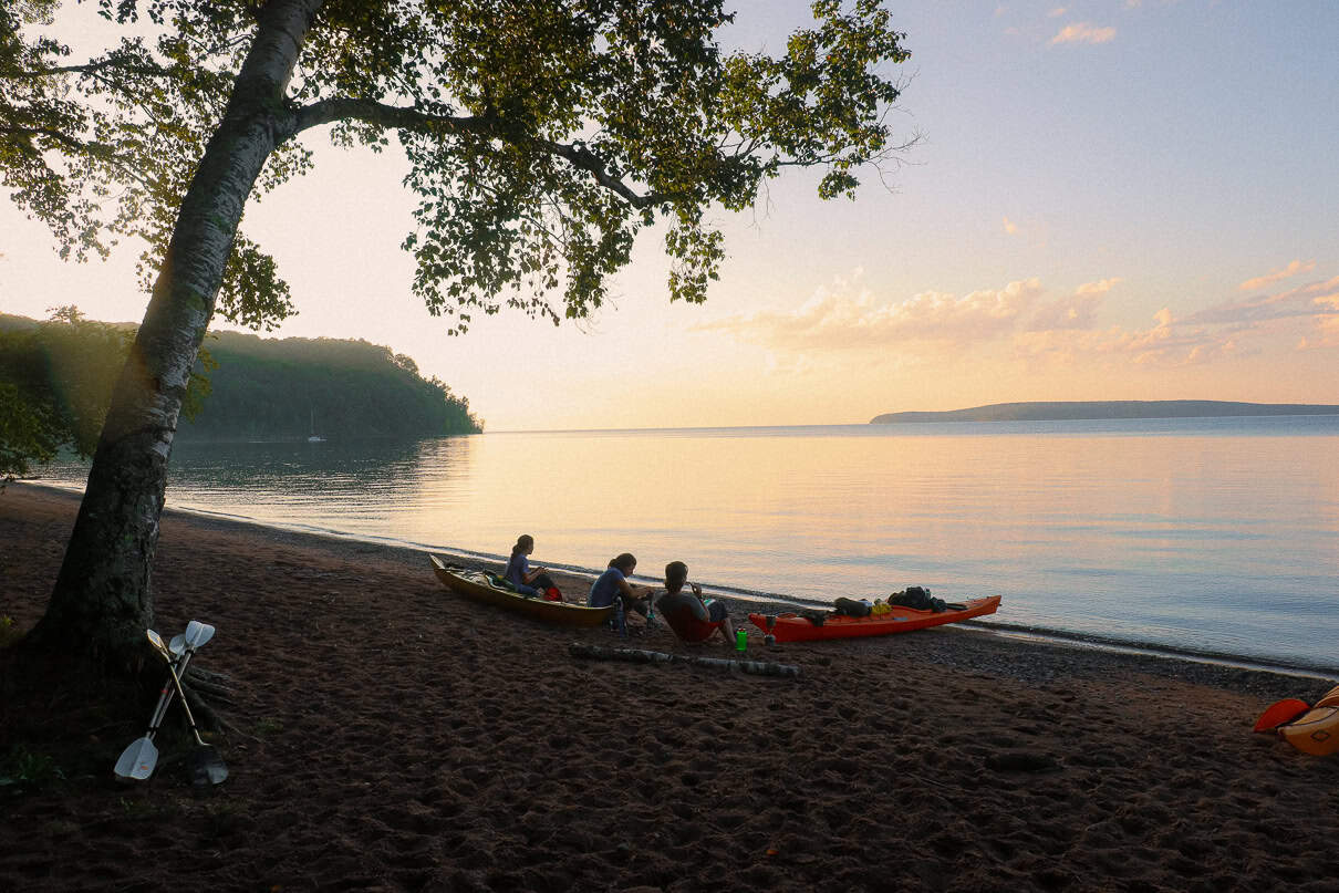 kayakers have dinner on a beach