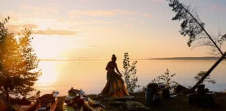 Why Kayak Camping Is Better Exercise Than Backpacking Image of a kayaker setting up camp.