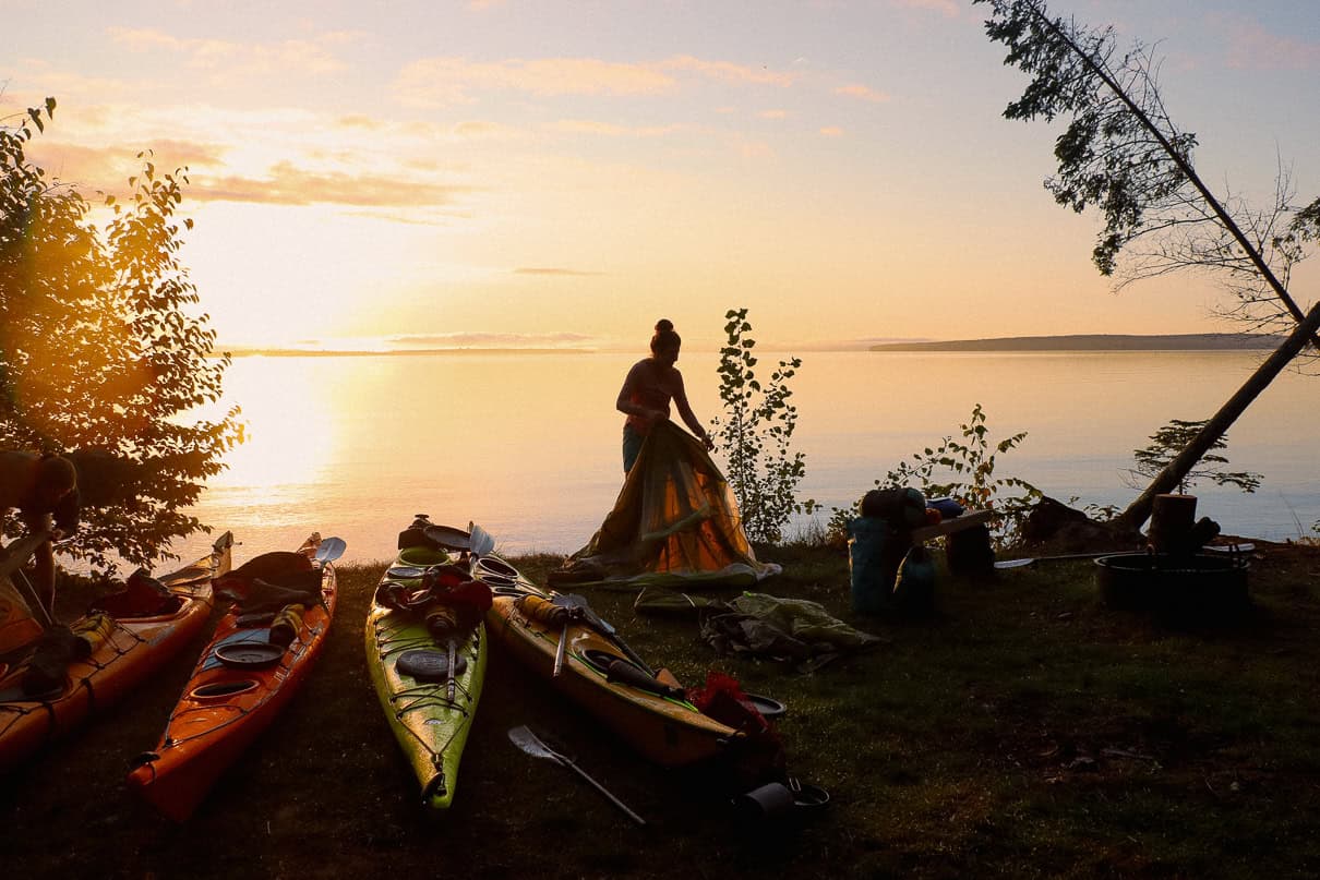 Image of a kayaker setting up camp.