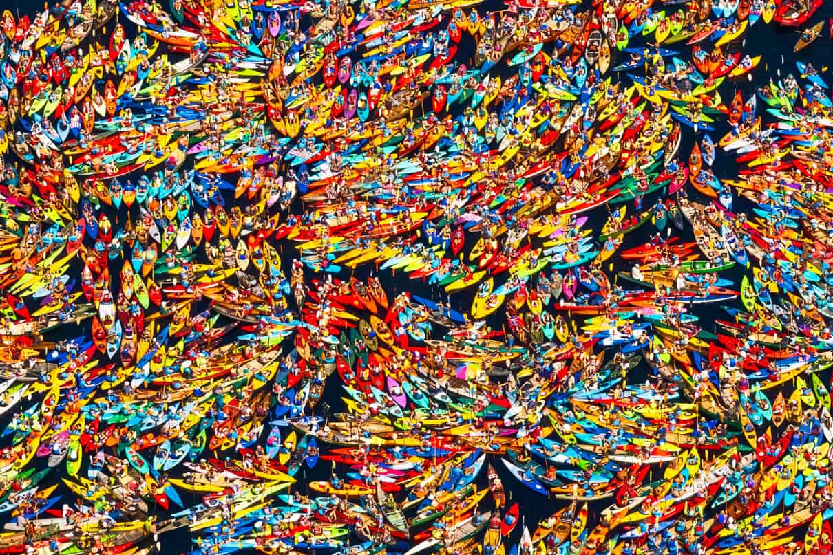 many kayaks rafted up on the water