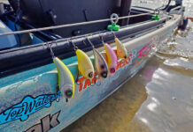 Wake Baits Go Saltwater Fishing a selection of wake baits are rigged to the side of a kayak before saltwater fishing