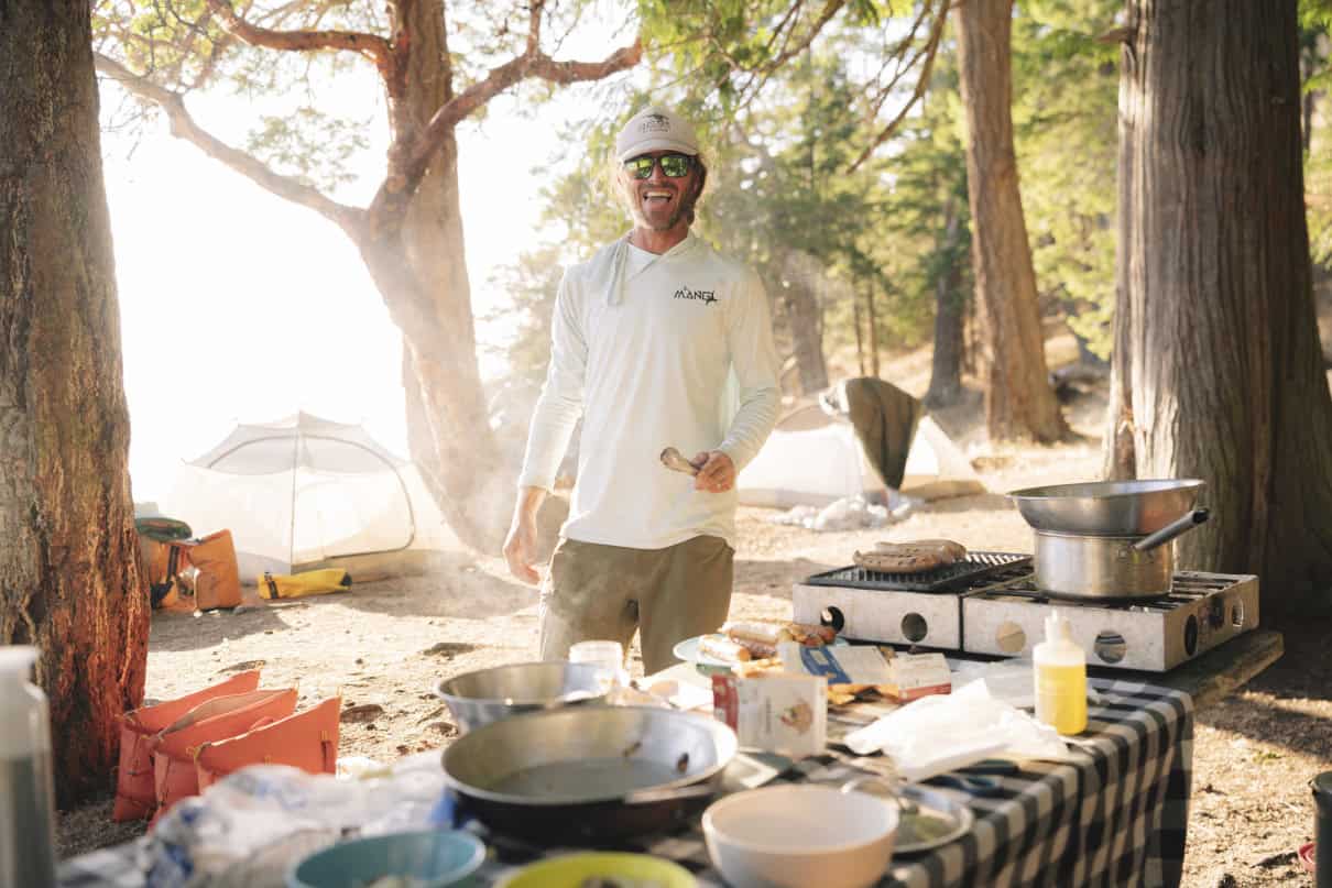 Guide cooks meal for tour group.
