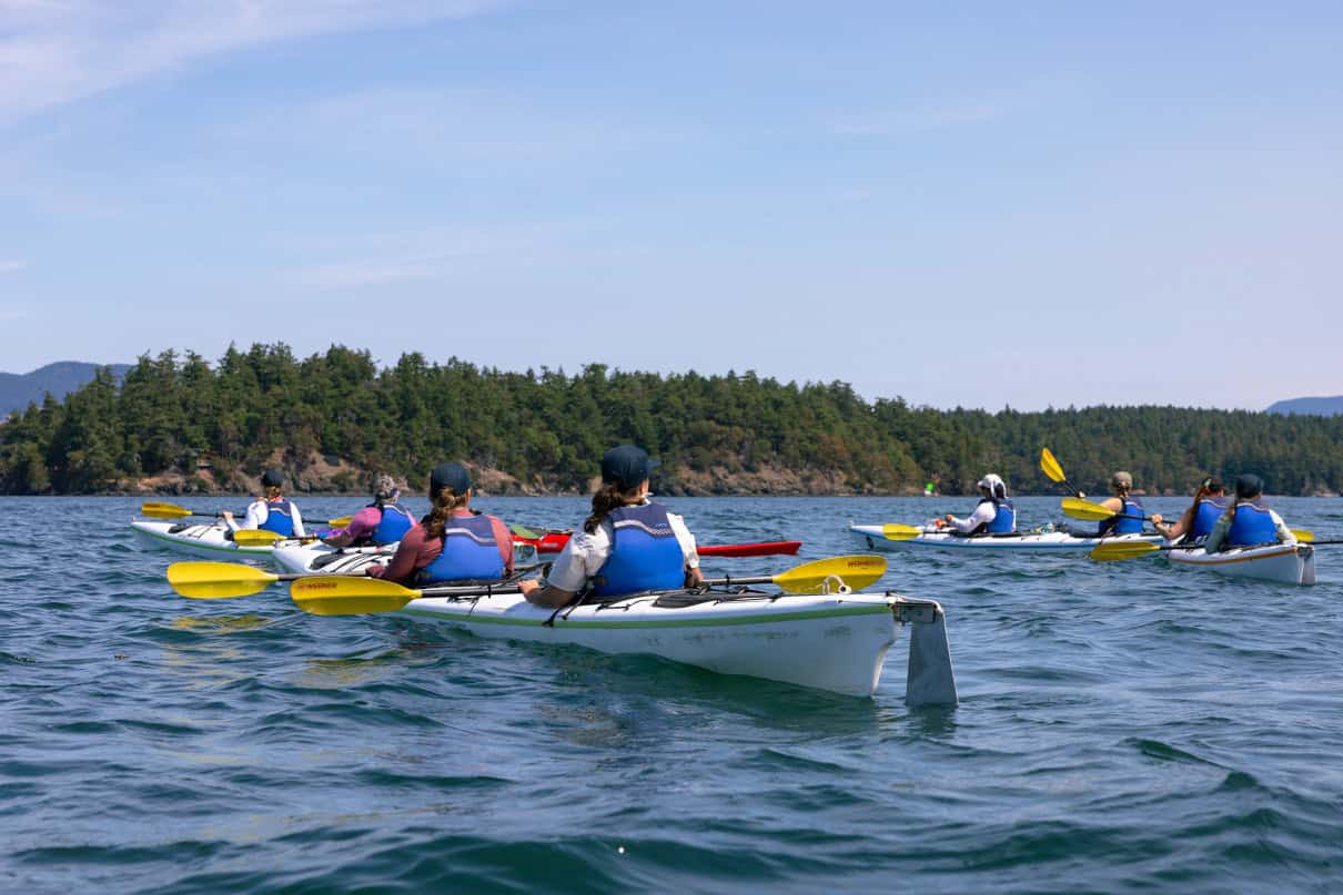 A group kayaks the San Juan Islands in Washington state.