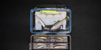 Build A Beginner Tackle Box With New Takes On Classic Lures an open tackle box on a black background with a selection of beginner fishing lures