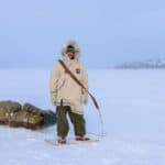 Inside Justin Barbour’s 4,000KM Journey Across The Hardest Route You’ve Never Heard Of Justin Barbour stands in snowshoes and parka with his loaded sled in the tundra