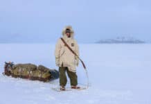 Inside Justin Barbour’s 4,000KM Journey Across The Hardest Route You’ve Never Heard Of Justin Barbour stands in snowshoes and parka with his loaded sled in the tundra
