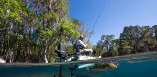 Where The Wildest Gear Innovations Really Start kayak angler fishes from a Bonafide XTR 130 fishing kayak equipped with Garmin Force Current motor, with a hooked fish just under the water in the foreground