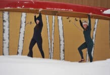 Best Base Layers For 2026 The author and Paddling Magazine editor-in-chief portaging a canoe wearing base layers.