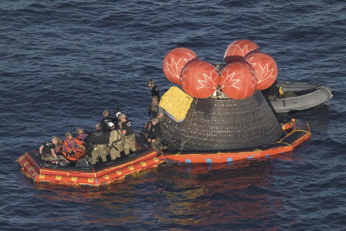 The Orion capsule from NASA's Artmeis II voyage, splashes down with astronauts aboard a recovery raft built by Jack's Plastic Welding.