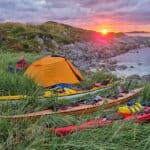 Back To Nordkapp: Retracing The Expedition That Launched The Modern Sea Kayak sunset view of a campsite with Nordkapp expedition kayaks during the anniversary trip