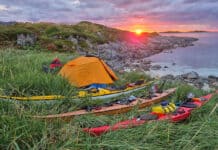 Back To Nordkapp: Retracing The Expedition That Launched The Modern Sea Kayak sunset view of a campsite with Nordkapp expedition kayaks during the anniversary trip