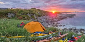 Back To Nordkapp: Retracing The Expedition That Launched The Modern Sea Kayak sunset view of a campsite with Nordkapp expedition kayaks during the anniversary trip