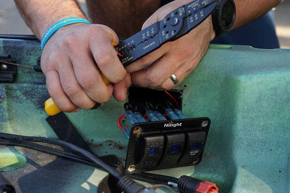Cory Byrnes strips the wires for his DIY kayak lighting
