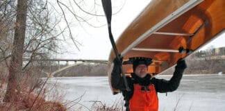 Close Call: How Canoeist Frank Bures Survived An Early-Season Capsize Frank Bures back at the scene of the capsize standing with canoe over his head in the wintertime