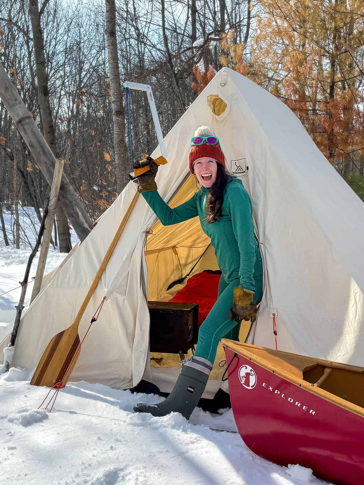 Paddling Magazine Editor Kaydi Pyette poses with a selection of her favorite shoulder season canoe camping gear