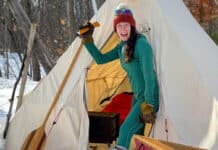 Paddling Magazine Editor Kaydi Pyette poses with a selection of her favorite shoulder season canoe camping gear