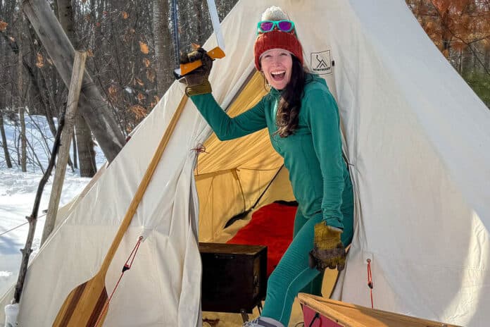 Paddling Magazine Editor Kaydi Pyette poses with a selection of her favorite shoulder season canoe camping gear